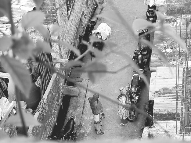A photograph of a bombed-out building, with people digging through the rubble in Yemen. Aid boxes from various humanitarian organizations are stacked on the side, untouched, showing the difficulty in reaching those affected.