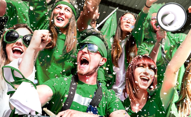 A team celebrating a major victory on the field, with confetti falling and players raising the trophy. The joy and excitement are palpable.