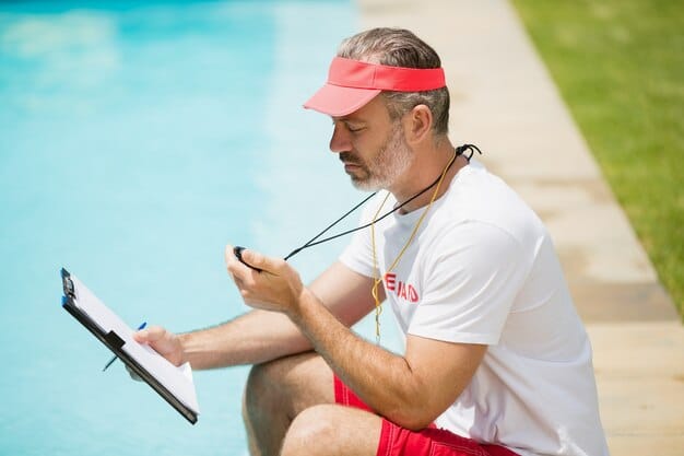 An NHL referee reviewing a video replay on a tablet during a game, focusing on a play where a player might have sustained a head injury.