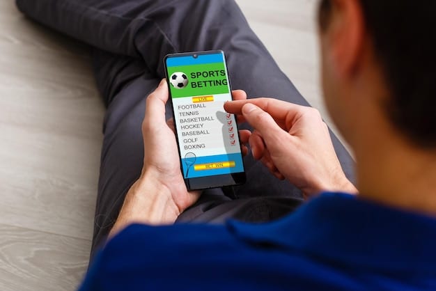 A close-up shot of a person's hands holding a smartphone, with a sports betting app displayed on the screen. The app shows live odds and betting options for an ongoing football game. The background is blurred, suggesting a public setting.