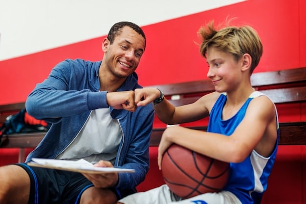 A photograph of a young American athlete receiving guidance from a coach during a training session. The image should highlight the personalized training and mentorship that is part of the US Olympic development program.