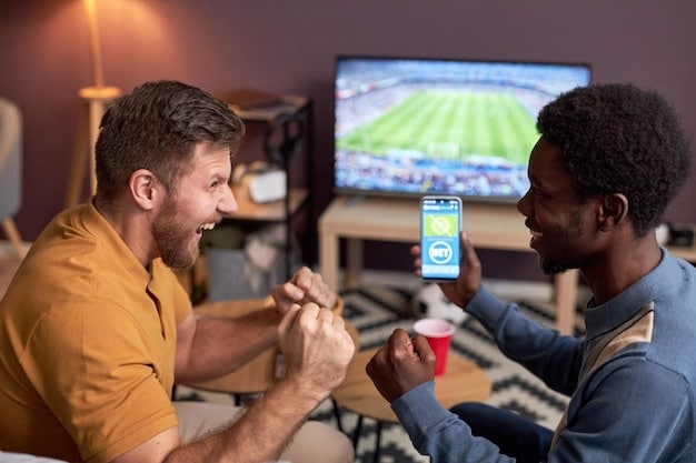 A fan intensely watching an NFL game on television, with a mobile phone in hand displaying a sports betting app. The scene is dim, with the screen light highlighting their focused expression.