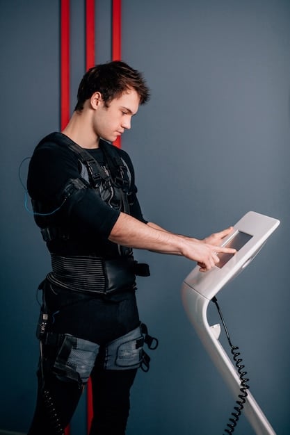 A sports scientist using motion capture sensors on an athlete's leg, displaying real-time data on a monitor in a high-tech lab.