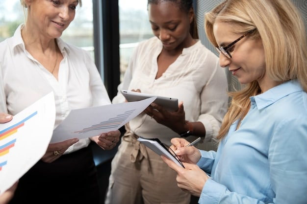 A group of diverse professionals collaborating around a table, reviewing charts and data related to sustainability metrics. The atmosphere is collaborative and focused, indicating a strategic planning session.