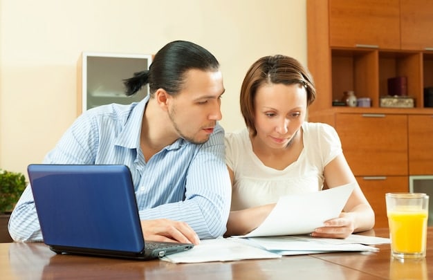 A family sitting at a table reviewing financial documents, with a laptop showing tax-related information. The image reflects the impact of budget proposals on household finances.